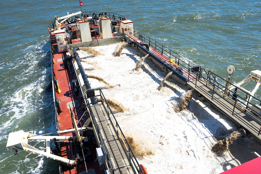 U.S. Army Corps of Engineers, Wilmington District’s, Hopper Dredge MURDEN pumps slurry during 24/7 dredging operations near an inlet in Ocean City, Md., Sept 20, 2021. Before dredging cycles, crew members conduct pre-dredge surveys and evaluate their findings to focus on shoaling during the dredging operations. (U.S. Army photo by Greg Nash)