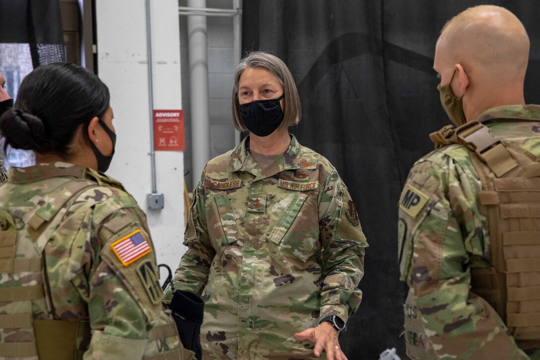 An Air Force general speaks to two service members.