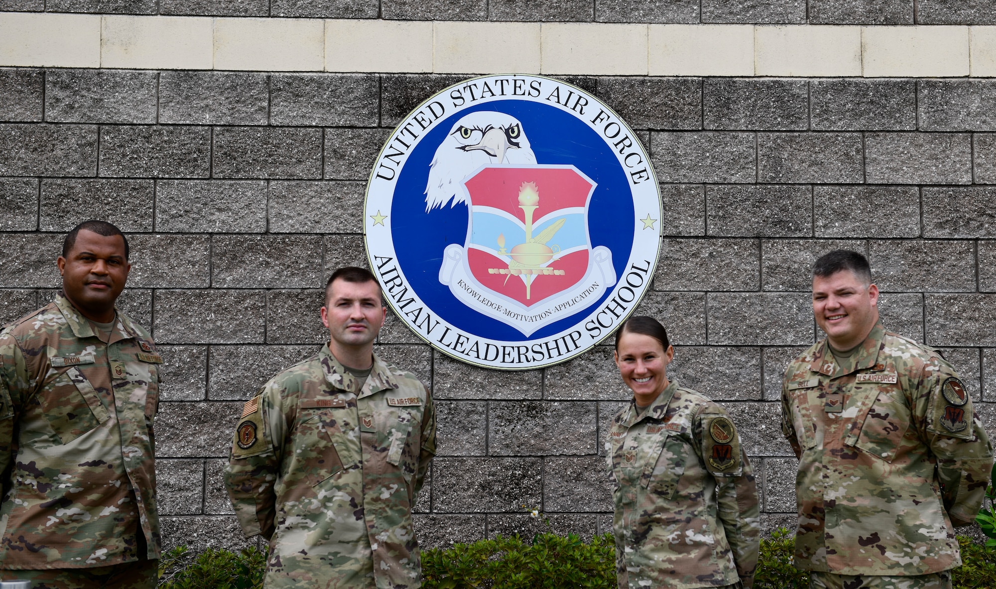 Four Airmen standing outside a building
