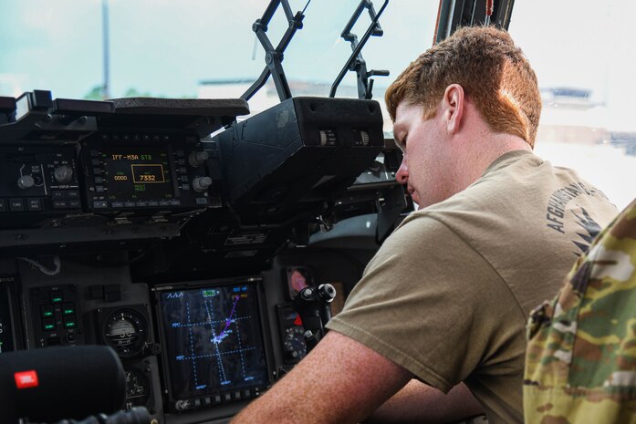 A U.S. Air Force pilot assigned to the 437th Airlift Wing prepares a C-17 Globemaster III for a flight to deliver cargo and troops to Afghanistan at Joint Base Charleston, S.C.