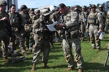 U.S. Army Soldiers assigned to the 82nd Airborne Division, Pope Army Airfield, N.C., receive a brief before loading onto a bus headed to board a C-17 Globemaster III at Joint Base Charleston, S.C.