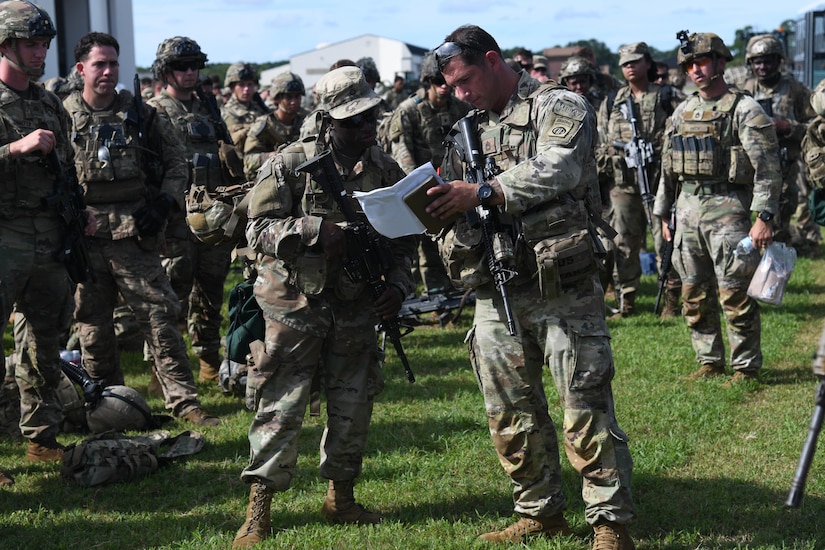 U.S. Army Soldiers assigned to the 82nd Airborne Division, Pope Army Airfield, N.C., receive a brief before loading onto a bus headed to board a C-17 Globemaster III at Joint Base Charleston, S.C.