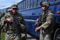 A U.S. Army Soldier assigned to the 82nd Airborne Division, Pope Army Airfield, N.C., loads onto a bus headed to board a C-17 Globemaster III at Joint Base Charleston, S.C.