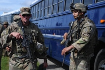 A U.S. Army Soldier assigned to the 82nd Airborne Division, Pope Army Airfield, N.C., loads onto a bus headed to board a C-17 Globemaster III at Joint Base Charleston, S.C.