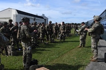 U.S. Army Soldiers assigned to the 82nd Airborne Division, Pope Army Airfield, N.C., receive a brief before loading onto a bus headed to board a C-17 Globemaster III at Joint Base Charleston, S.C.