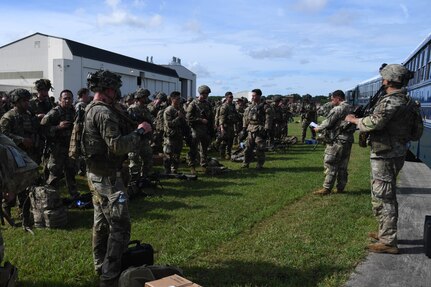 U.S. Army Soldiers assigned to the 82nd Airborne Division, Pope Army Airfield, N.C., receive a brief before loading onto a bus headed to board a C-17 Globemaster III at Joint Base Charleston, S.C.