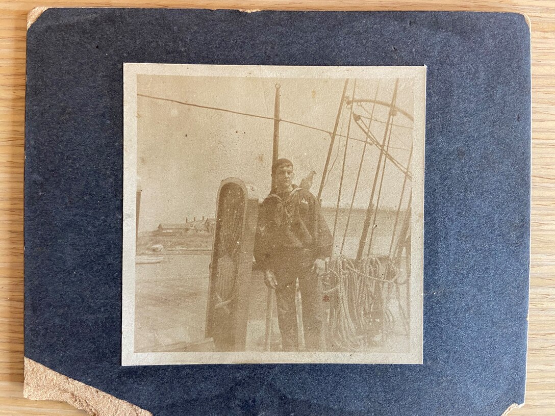 A gangway board aboard an unidentified Revenue Cutter along with an enlisted crewman and pet.