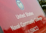 The U.S. Naval Community College yard sign stands in front of the USNCC. The sign was recently installed in time for the staff to celebrate the opening of applications for Pilot II of the USNCC. The USNCC is the community college of the Navy, Marine Corps, and Coast Guard and provides an opportunity for active duty enlisted Sailors, Marines and Coast Guardsmen to earn a naval-relevant associate degree through asynchronous online courses taught by military-friendly and experienced educators. (U.S. Navy photo by Chief Mass Communication Specialist Xander Gamble)