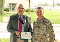 Col. John “Ryan” Bailey, right, commander of the U.S. Army Medical Materiel Agency, presents Chris Roan with the Civilian Service Commendation Medal during Roan’s retirement ceremony Sept. 17 at Fort Detrick, Maryland. Roan retires with nearly 40 years of federal service.