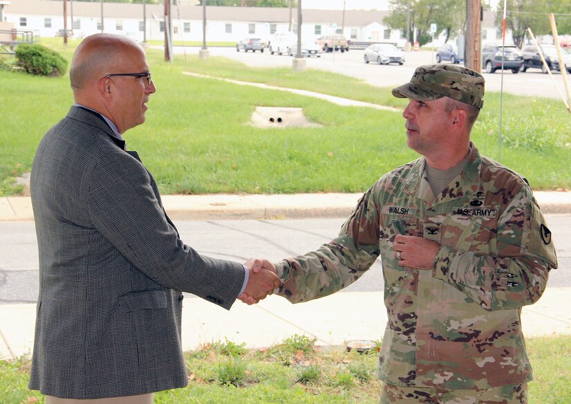 Chris Roan, left, shakes hands with Col. Timothy Walsh, deputy commander of U.S. Army Medical Logistics Command, during Roan’s retirement ceremony Sept. 17 at Fort Detrick, Maryland. Roan retires with nearly 40 years of federal service.