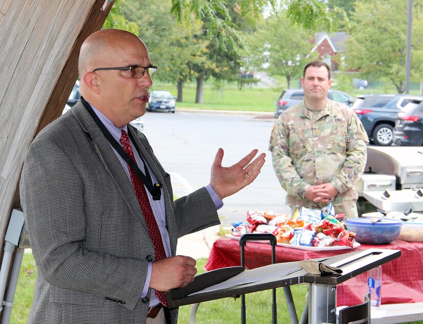 Chris Roan, left, speaks during his retirement ceremony Sept. 17 at Fort Detrick, Maryland. Looking on is Maj. Zachary Patterson. Roan retires with nearly 40 years of federal service.