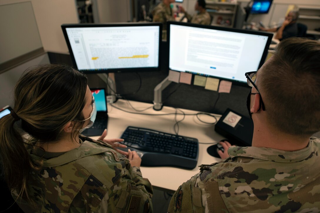 Airmen work at computer