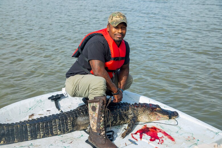 WALLISVILE LAKE, Texas (Sept. 29, 2021) – Reese Green, a combat injured veteran, poses with the 6-foot-plus alligator he hunted at the U.S. Army Corps of Engineers’ (USACE) Wallisville Lake Project during the Lonestar Warriors Outdoors Gator Hunt. The event is a sponsored alligator hunt for combat injured veterans. In partnership with the Texas Parks and Wildlife Department game wardens and Lone Star Warriors Outdoors, USACE Galveston hosted the hunt as a way to successfully manage alligator populations in support of environmental stewardship and maintain its wounded warrior outreach program.