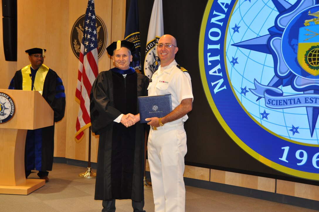 LCDR Alex Homme receives award while earning his master's degree.