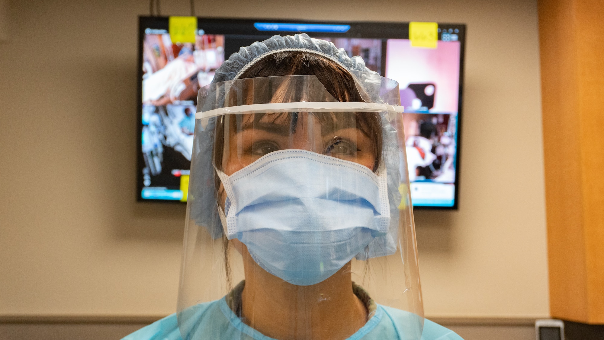 U.S. Navy Lt. Cmdr. Diana Tran-Yu, the officer in charge of Task Force Lafayette with Task Force Lafayette, Navy Medicine Readiness Training Command, at Bethesda, Maryland, reflects in front of a patient viewing monitor in the COVID critical care ward in Ochsner Lafayette General Medical Center at Lafayette, Louisiana on Sept. 9, 2021. The task force, which specializes in critical care treatment, established a new critical care ward in the hospital to help take care of the sickest patients effected by COVID. U.S. Northern Command, through U.S. Army North, remains committed to providing flexible Department of Defense support to the whole-of-government COVID response. (U.S. Army photo by Sgt. 1st Class Timothy Hughes)