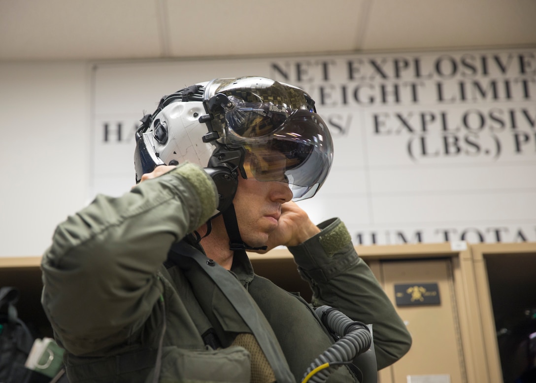 U.S. Marine Corps Lt. Col. Alexander Goodno, commanding officer of Marine Fighter Attack Squadron (VMFA) 225, tightens his helmet before heading to the flight line at Marine Corps Air Station Yuma, Ariz., September 25, 2021.