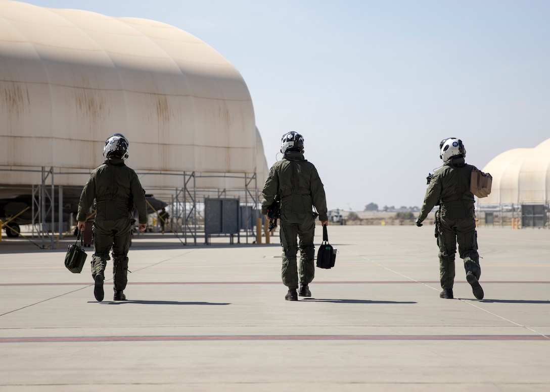 U.S. Marine Corps pilots with Marine Fighter Attack Squadron (VMFA) 225 walk to their aircraft to begin their final checks before flight at Marine Corps Air Station Yuma, Ariz., September 27, 2021.
