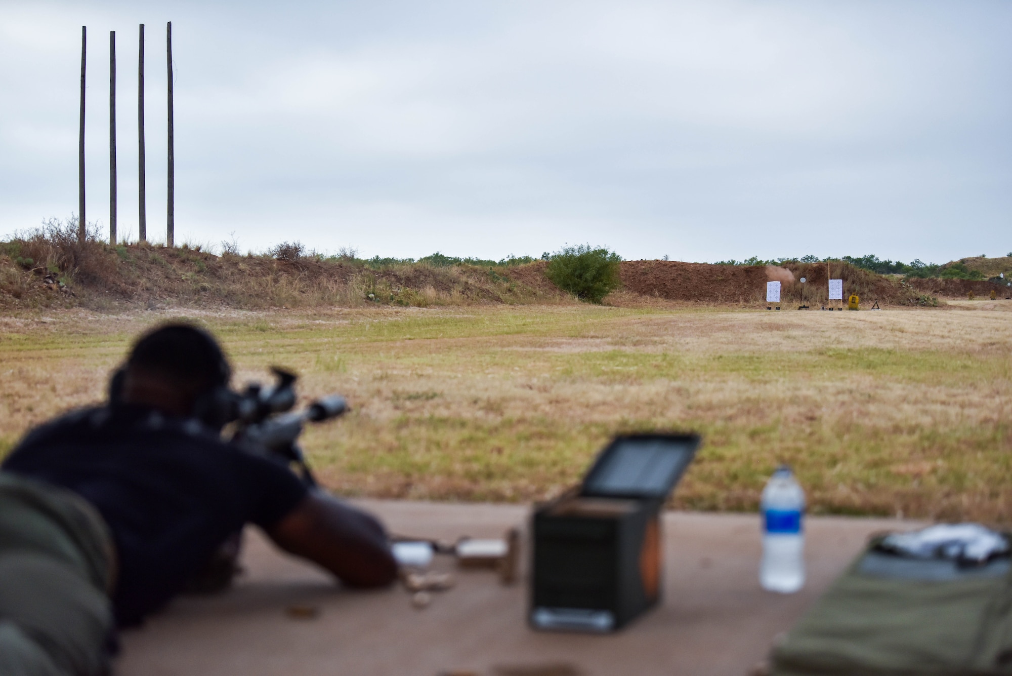 U.S. Air Force Staff Sgt. Christopher Little, 17th Security Forces Squadron flight chief, fires at a target during the joint marksmanship training course at the San Angelo Police Department firing range in San Angelo, Texas, Sept. 29, 2021. Members shot at targets from various distances while performing corrections on first-round impacts to help them improve their accuracy. (U.S. Air Force photo by Senior Airman Jermaine Ayers)