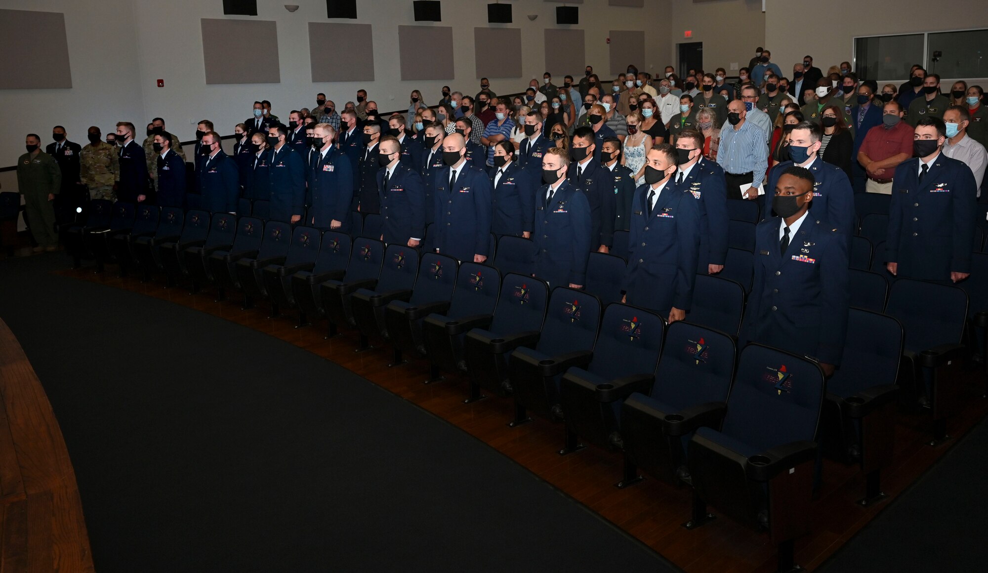 U.S Air Force Specialized Undergraduate Pilot Training graduates, stand at attention during the playing of the Guatemalan, Japanese, and United States National Anthems, Oct.1, 2021, on Columbus Air Force Base, Miss. Thirty-two officers graduated in class 21-16, becoming the U.S. Air Forces newest aviators. (U.S Air Force photo by Airman 1st Class Jessica Haynie)