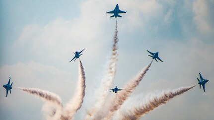 Six Air Force Thunderbird jets perform an aerial maneuver