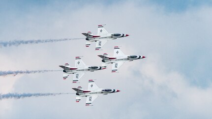 Four Air Force Thunderbird jets fly in formation