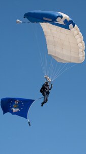 military parachutist prepares to land on the airfield