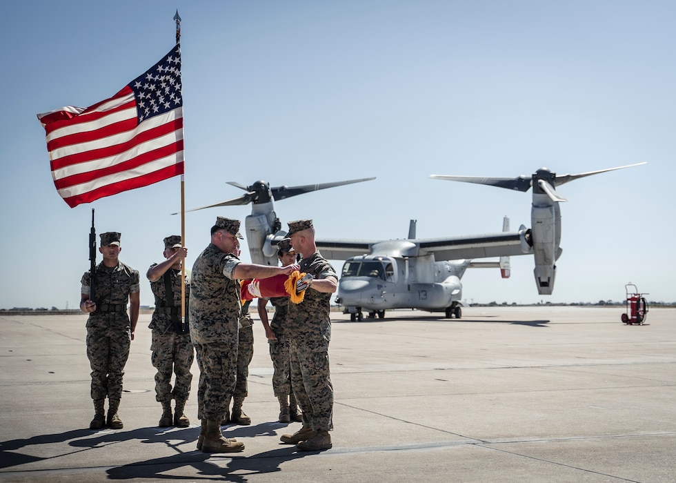 U.S. Marine Corps Lt. Col. James Clifford Ford III, commanding officer, Marine Medium Tilt Rotor Squadron (VMM) 166, Marine Aircraft Group (MAG) 16, 3rd Marine Aircraft Wing (MAW), and Sgt. Maj. Mohammad A. Arzola, sergeant major, VMM-166, MAG-16, 3rd MAW, case the colors for VMM-166 at a deactivation ceremony on Marine Corps Air Station Miramar, Oct. 1, 2021. VMM-166 was deactivated in accordance with Force Design 2030, as the latest effort to continue to have an advantage over adversaries. (U.S. Marine Corps photo by Cpl. Carlos Kealy)