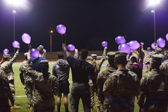 Goodfellow members hold purple balloons in the air at the Suicide Awareness 24-Hour Run/Walk on Goodfellow Air Force Base.