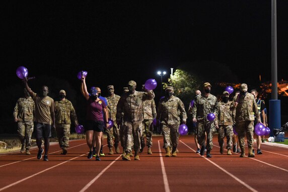 Goodfellow Air Force Base leadership walk together on the Mathis Field track during the Suicide Awareness 24-Hour Run/Walk at the Mathis Fitness Center.