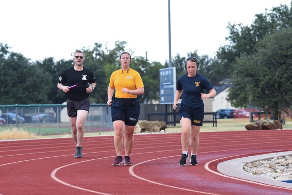 Participants run with batons around the track during the Suicide Awareness 24-Hour Run/Walk on Goodfellow Air Force Base.