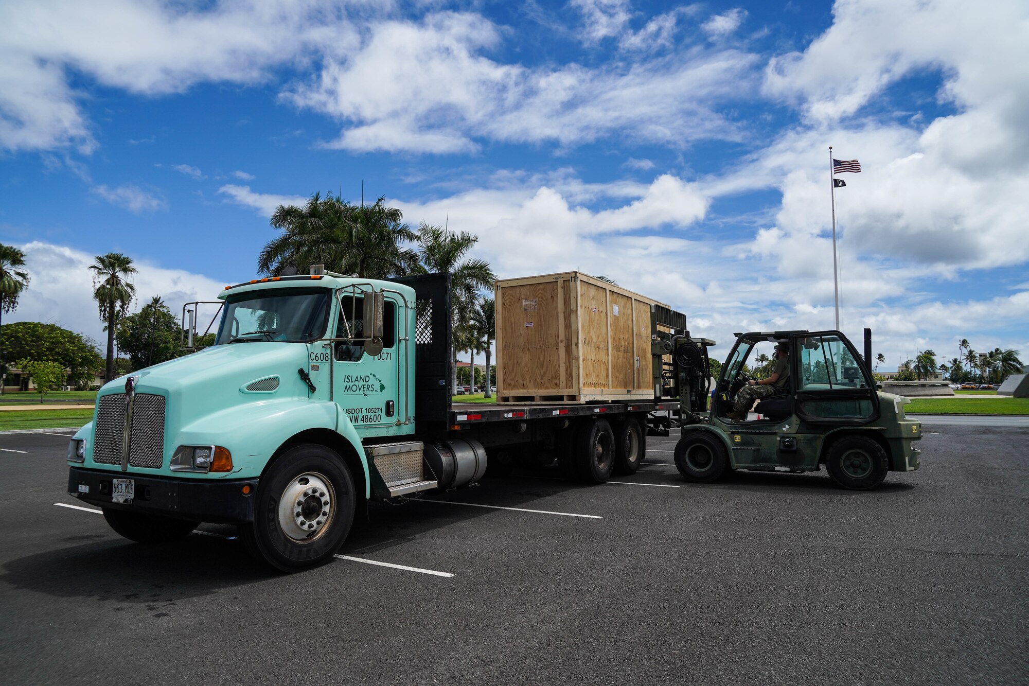 Master Sgt. Michael Depue, 15th Maintenance Squadron maintenance flight chief, operates a 10K forklift to lift a crate from a shipment vehicle at Joint Base Pearl Harbor-Hickam, Hawaii, Sept. 28, 2021. The containers held two static model aircraft, a Curtiss P-36A Hawk and a P-40B Warhawk, that are now displayed outside of the 15th Wing Headquarters building. (U.S. Air Force photo by Senior Airman Alan Ricker)