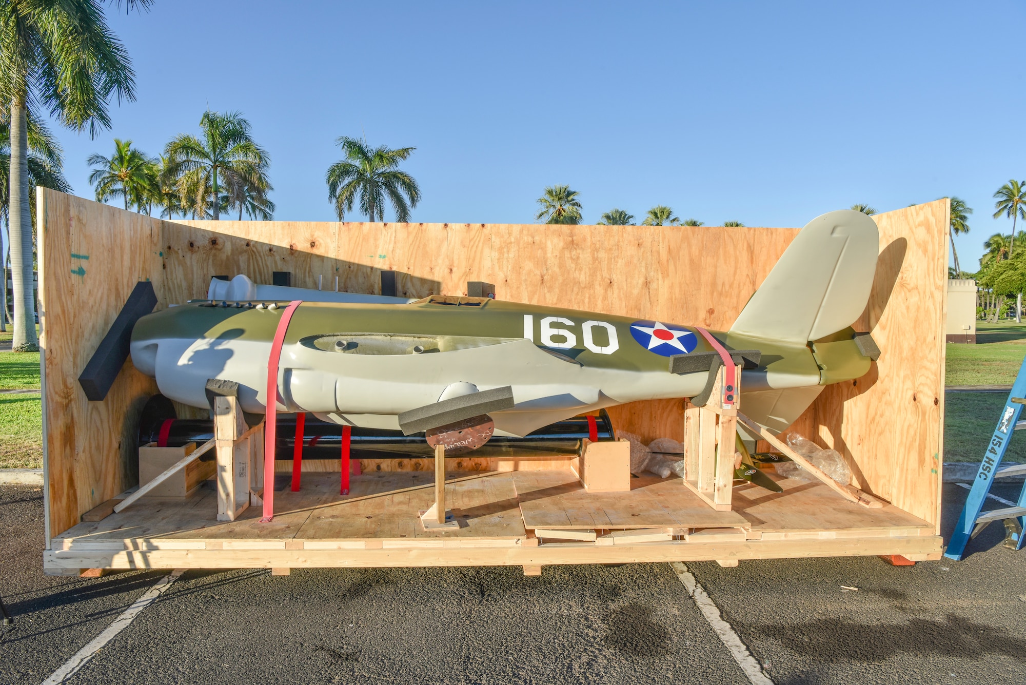 A half-scale model of a P-40B Warhawk arrives in front of the 15th Wing headquarters building at Joint Base Pearl Harbor-Hickam, Hawaii Sept. 29, 2021. The P-40B Warhawk represents the aircraft piloted by U.S. Army Air Corps 2nd Lt. George S. Welch, who shot down four enemy aircraft during the attack on Pearl Harbor on Dec. 7, 1941. (U.S. Air Force photo by Tech. Sgt. Anthony Nelson Jr.)