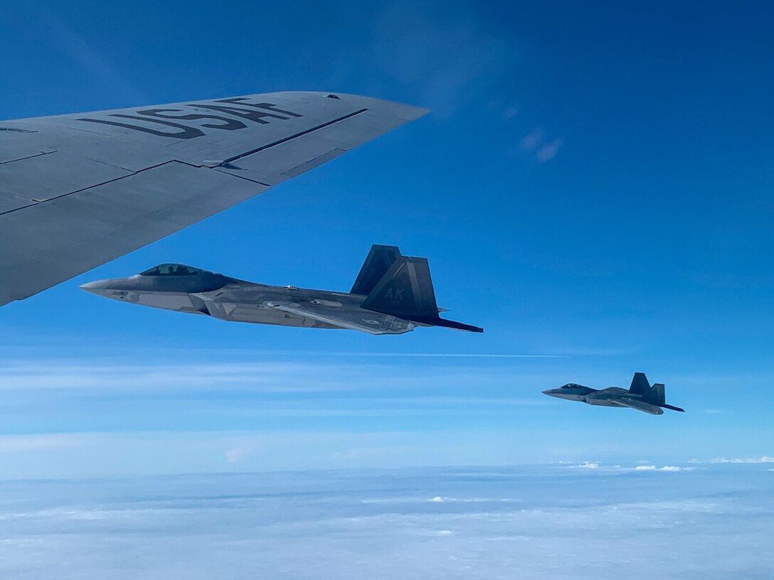 Jets flying alongside tanker