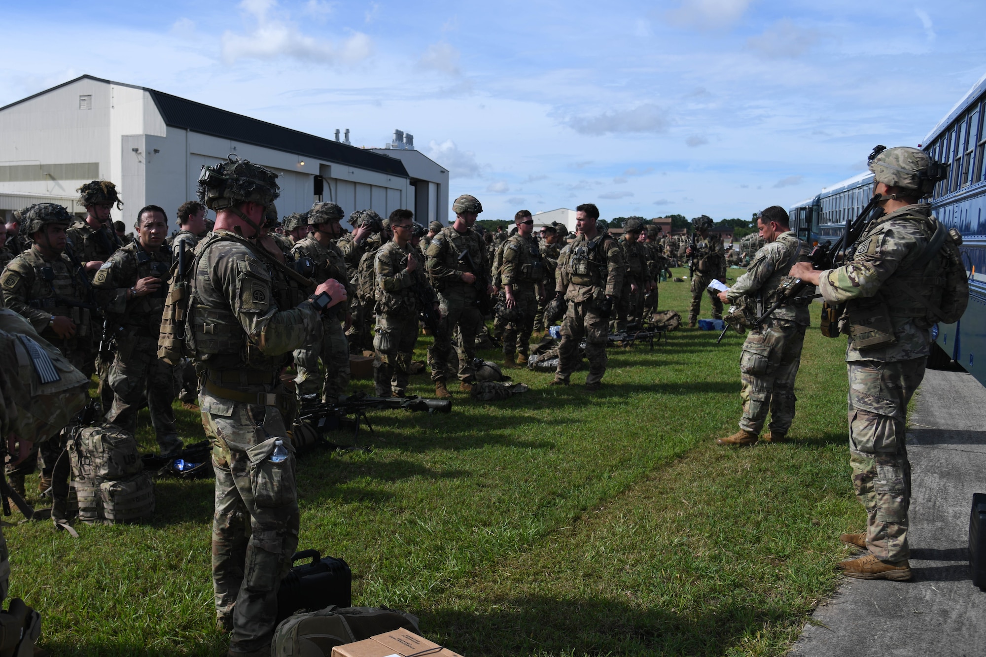 U.S. Army Soldiers assigned to the 82nd Airborne Division, Pope Army Airfield, N.C., receive a brief before loading onto a bus headed to board a C-17 Globemaster III at Joint Base Charleston, S.C.