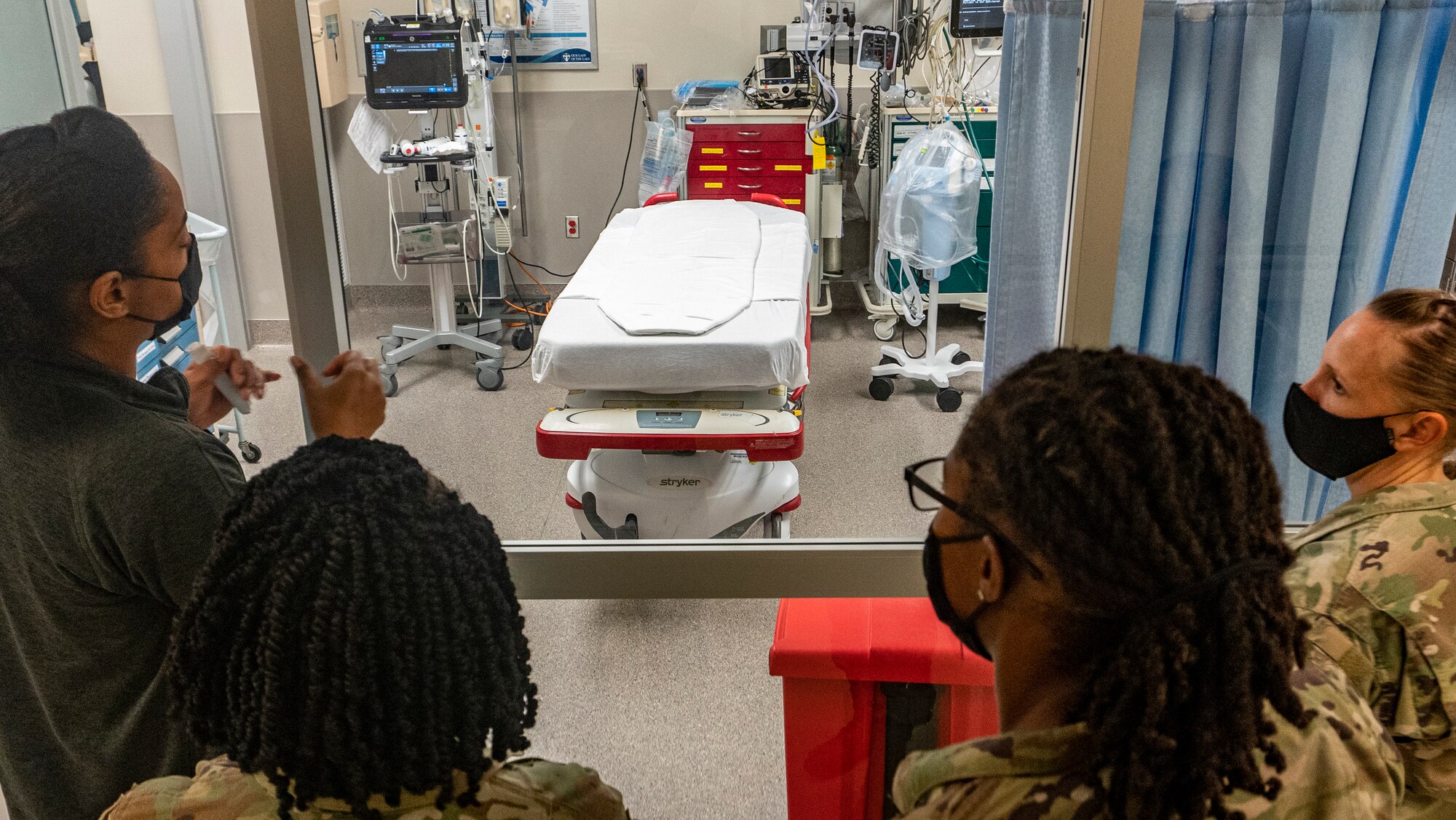 (From left to right) U.S. Air Force Master Sgt. Rosa Barringer, a respiratory care practitioner; Lt. Col. Melissa Beasely, officer in charge of Task Force Baton Rouge; 1st Lt. Brianna Green, an operations officer; and Master Sgt. Stephanie Todaro, a senior enlisted leader; all assigned to Task Force Baton Rouge, 81st Medical Group, at Keesler Air Force Base, Mississippi, discuss lessons Barringer has learned as a member of the task force in Our Lady of the Lake Regional Medical Center at Baton Rouge, Louisiana on Sept. 8, 2021. Barringer said there are some practices she’d like to take back to her home station to further improve its efficiency in the trauma bay. U.S. Northern Command, through U.S. Army North, remains committed to providing flexible Department of Defense support to the whole-of-government COVID response. (U.S. Army photo by Sgt. 1st Class Timothy Hughes)