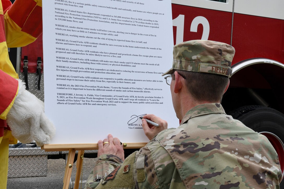 Col. Jeremy Fields, 319th Reconnaissance Wing vice commander, signs the 2021 National Fire Prevention Week proclamation on Grand Forks Air Force Base, N.D. Oct. 1, 2021. This marks the start of Grand Forks AFB’s campaign during NFPW. (U.S. Air Force Photo by Airman 1st Class Ashley Richards)
