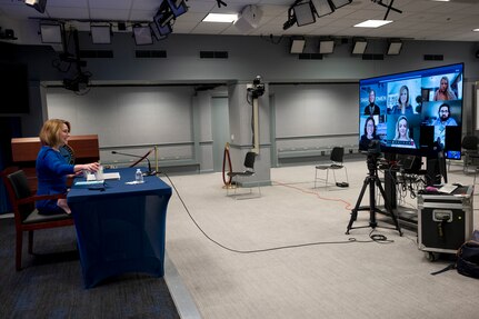 A woman participates in a virtual conversation.