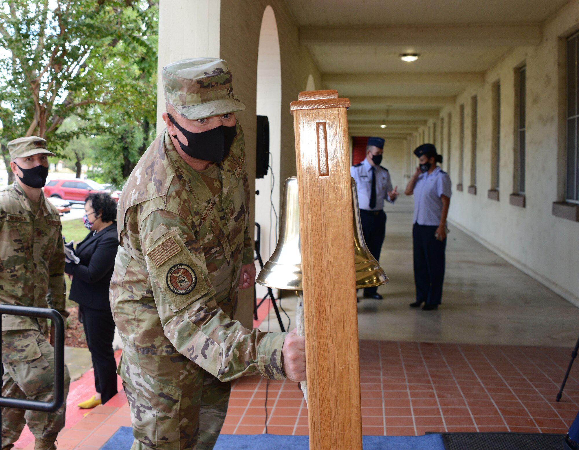 Master Sgt. Daniel McIntyre, Air Force Recruiting Service first sergeant, rings the bell during an AFRS ceremony celebrating each of the Total Force recruiting partners, active duty, Air Force Reserve and Air National Guard, making goal and reaching end strength for Fiscal 2021.