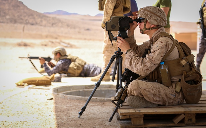 CAMP TITIN, Jordan (Sept. 21, 2021) U.S. Marine assigned to Fleet Anti-Terrorism Security Team acts as a spotter for a Jordanian Marine while participating in a gun shoot during Exercise Infinite Defender 21. Infinite Defender 21 is an annual, bilateral maritime infrastructure protection, explosive ordnance disposal, anti-terrorism force protection, and maritime security exercise between the Jordanian Armed Forces and U.S. Naval Forces Central Command, meant to enhance partnership and interoperability. (U.S. Marine Corps photo by Sgt. Benjamin McDonald)