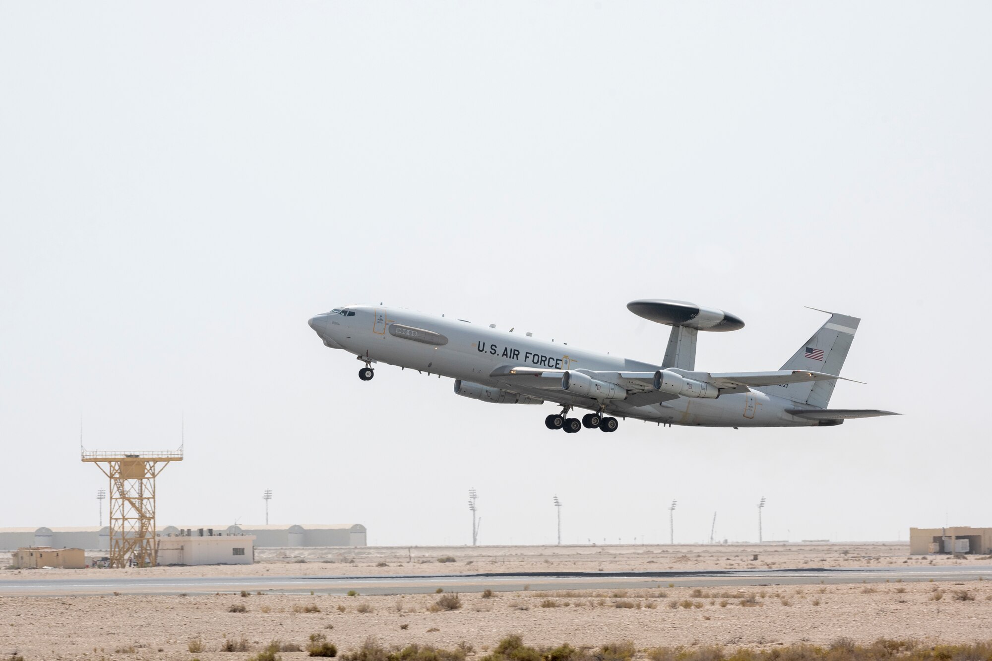 E-3 sentry taking off in mid air over runway