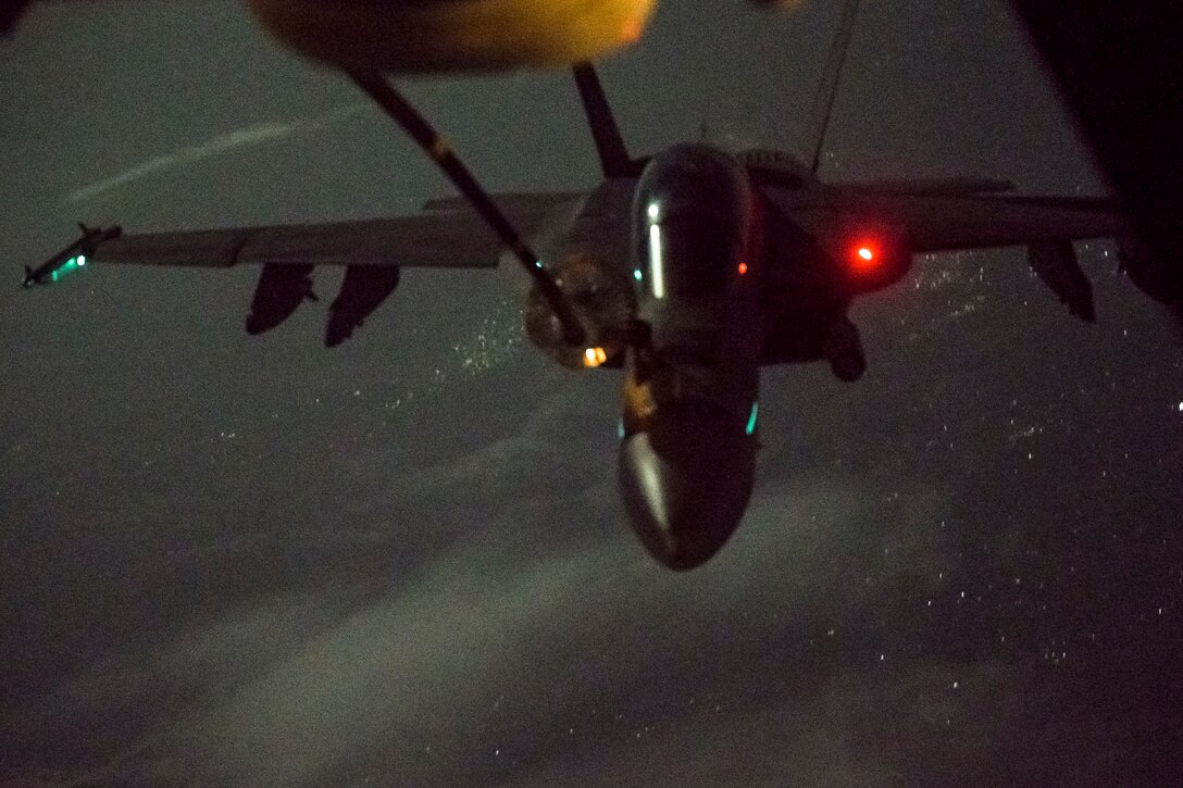 F/A-18 Hornet aircraft approaches a KC-10 Extender aircraft over Afghanistan to receive fuel