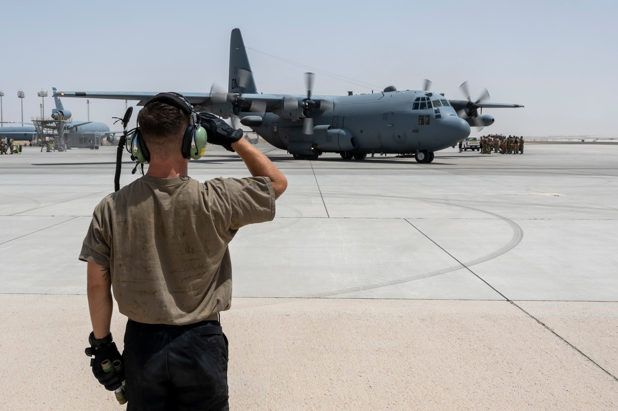 Airman salutes Compass Call aircraft as it taxis
