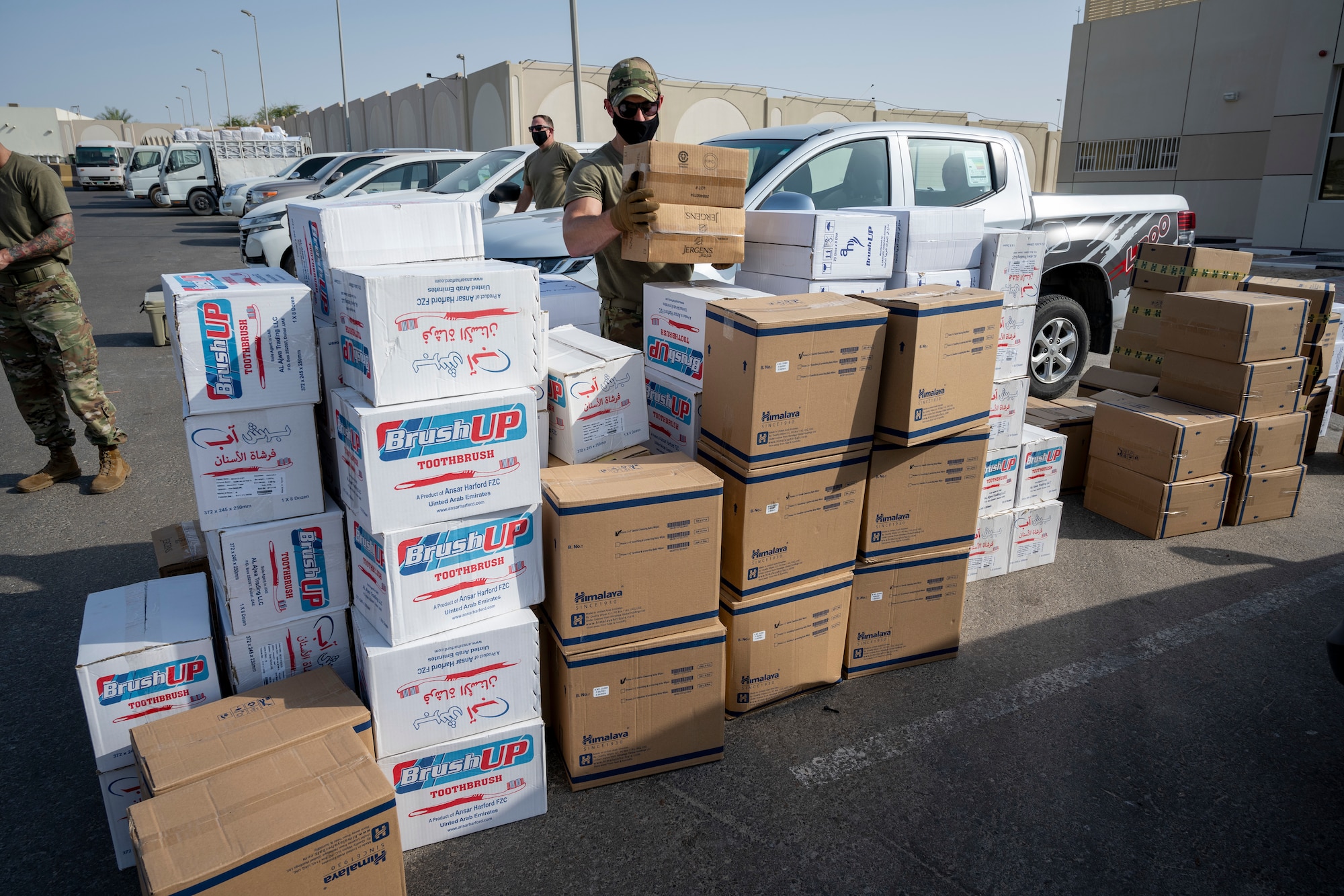 Airmen loading and packing pallets of humanitarian supplies