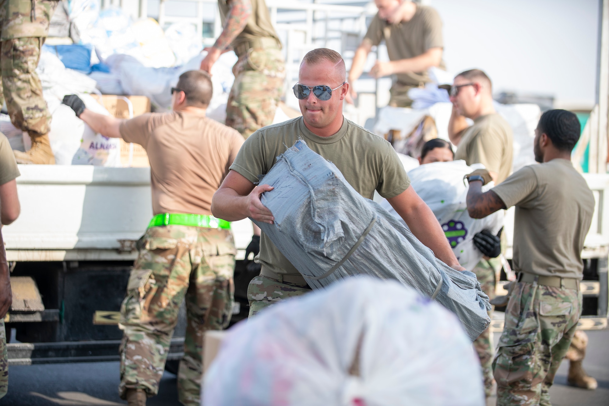 Airmen loading and packing pallets of humanitarian supplies