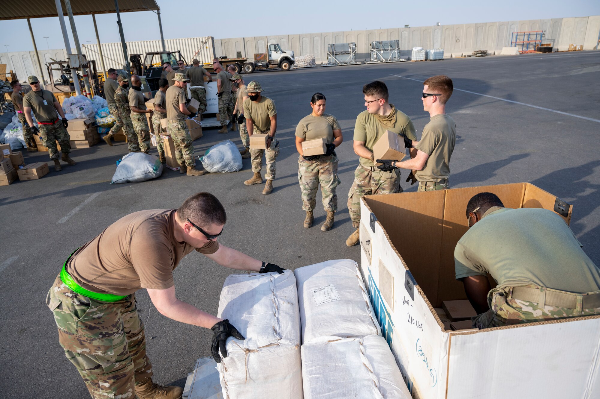 Airmen loading and packing pallets of humanitarian supplies