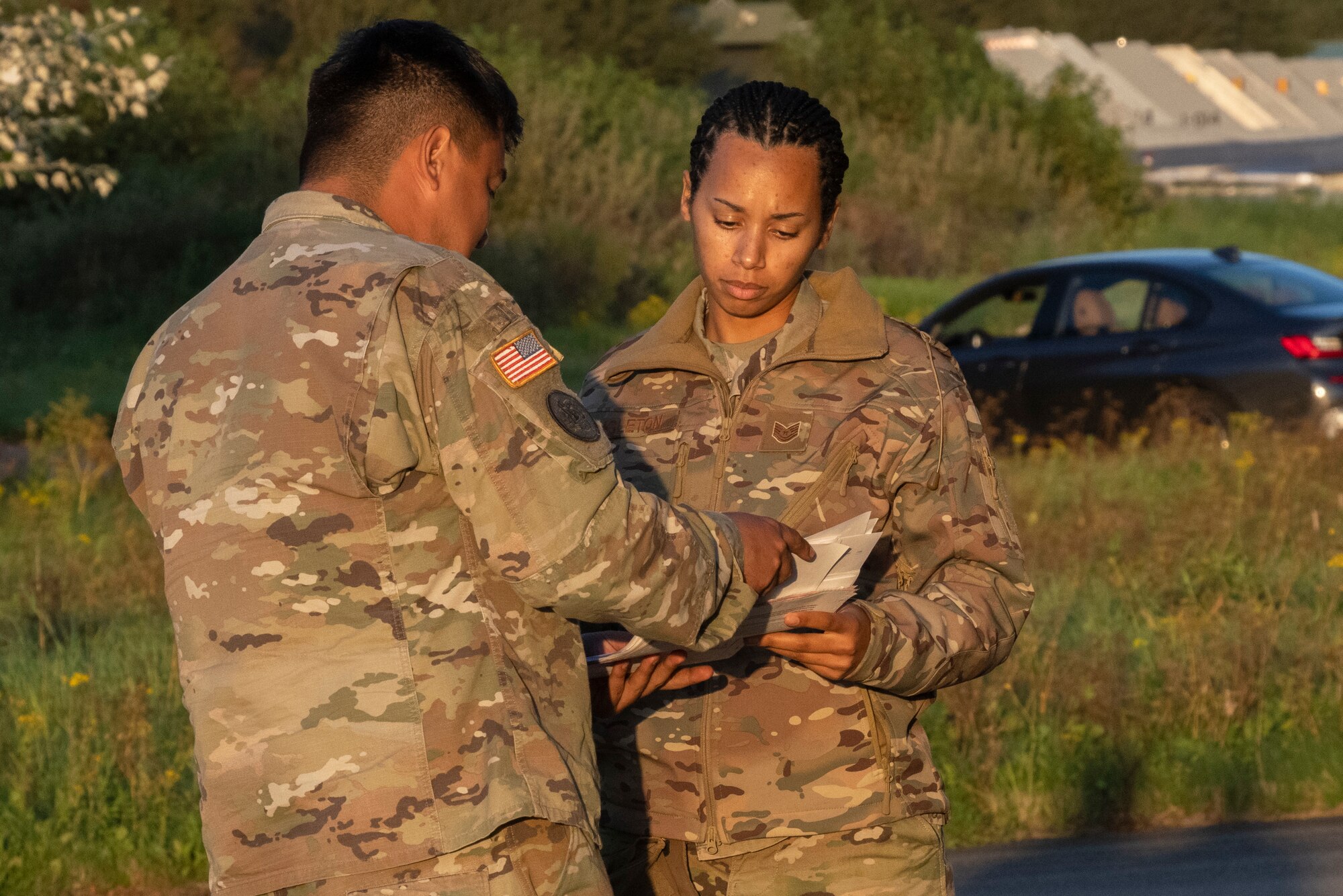 U.S. Air Force Tech Sgt. Kendra Singleton, 52nd Maintenance Squadron Ammo inspection production supervisor, checks receipt documents with a soldier from the 21st Theater Sustainment Command while receiving cargo at Leeuwarden Air Base, Netherlands, September 13. 2021. The movement of live munitions marked a first during an Agile Combat Employment exercise for United States Air Forces in Europe-Air Forces Africa. (U.S. Air Force photo by Tech. Sgt. Anthony Plyler)
