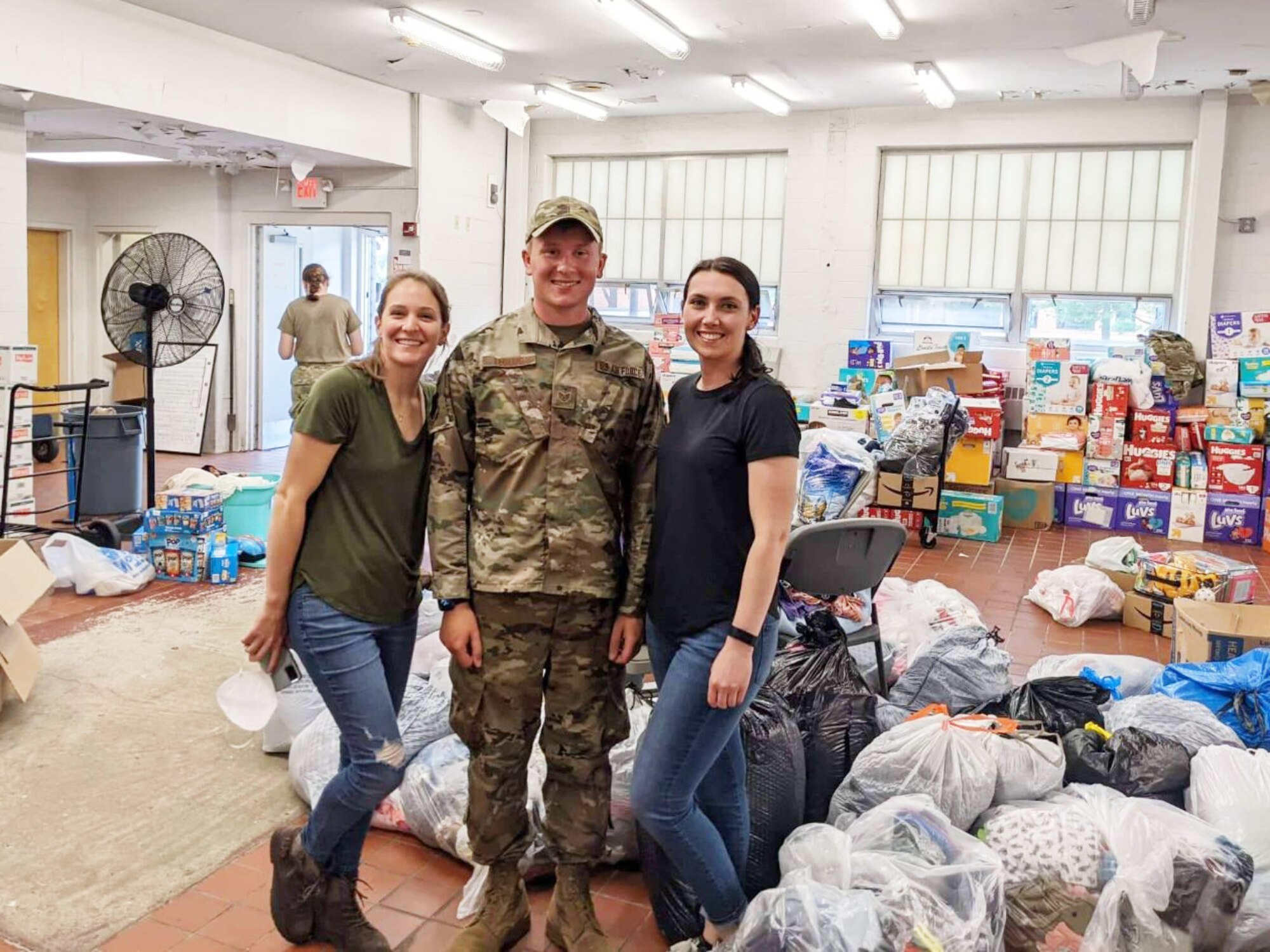 From left to right: Senior Airman Katlyn Legerstee, Staff Sgt. Jake Leonard, and Tech. Sgt. Cassandra Dowling, of the 157th Air Refueling Wing, inside the donation center at Joint Base McGuire-Dix-Lakehurst, Sept. 17, 2021.