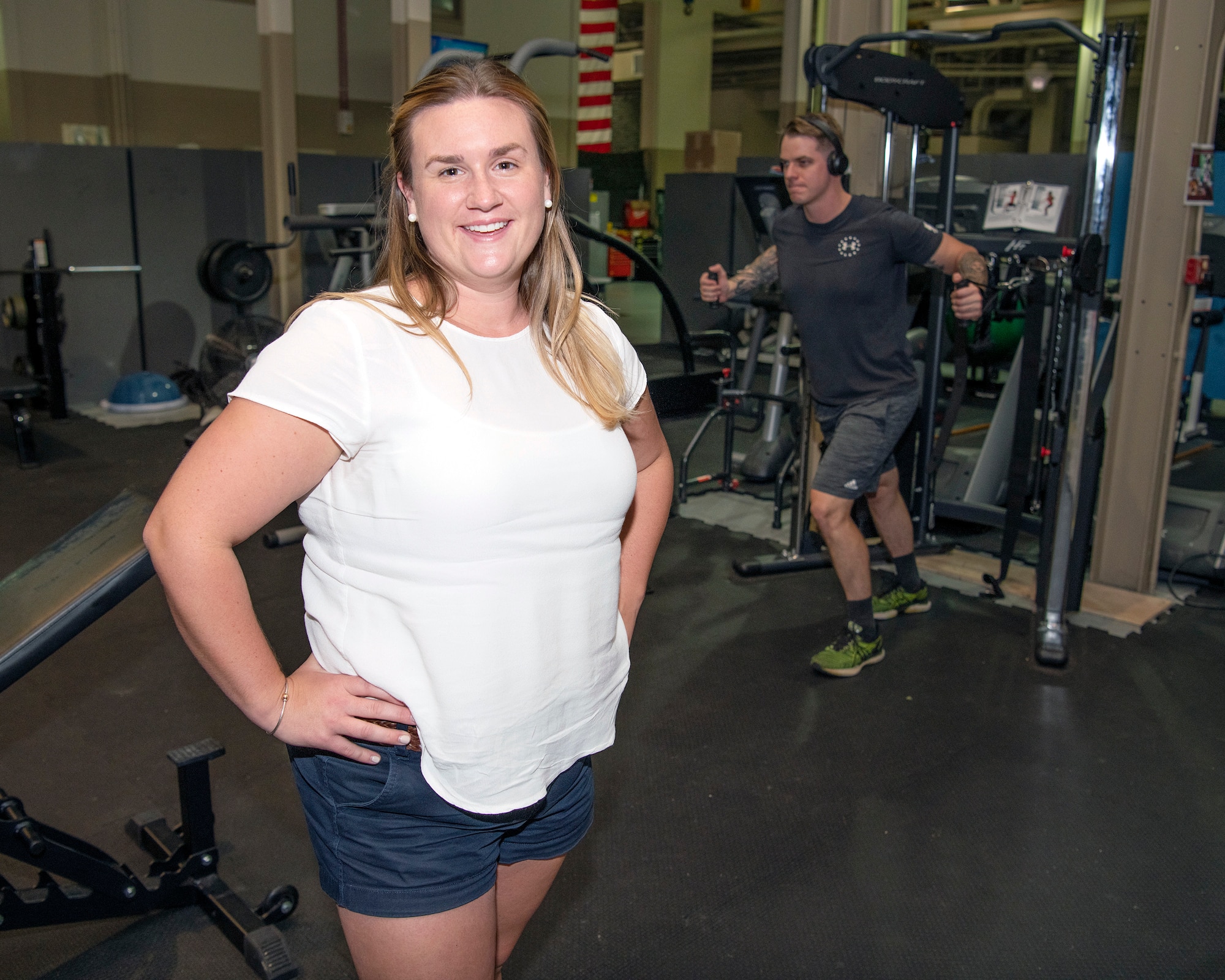 Ellie Goldense, an athletic trainer with the Preservation of the Force and Family takes the time for a photo in her work area at Hurlburt Field, Florida, Sept. 23, 2021. Goldense is the only athletic trainer embedded into the 2nd Special Operations Squadron and supports the whole second shift team for the flying units within the 2nd SOS, 65th Special Operations Squadron, and the 311th Special Operations Intelligence Squadron. (U.S. Air Force photo by Michelle Gigante)