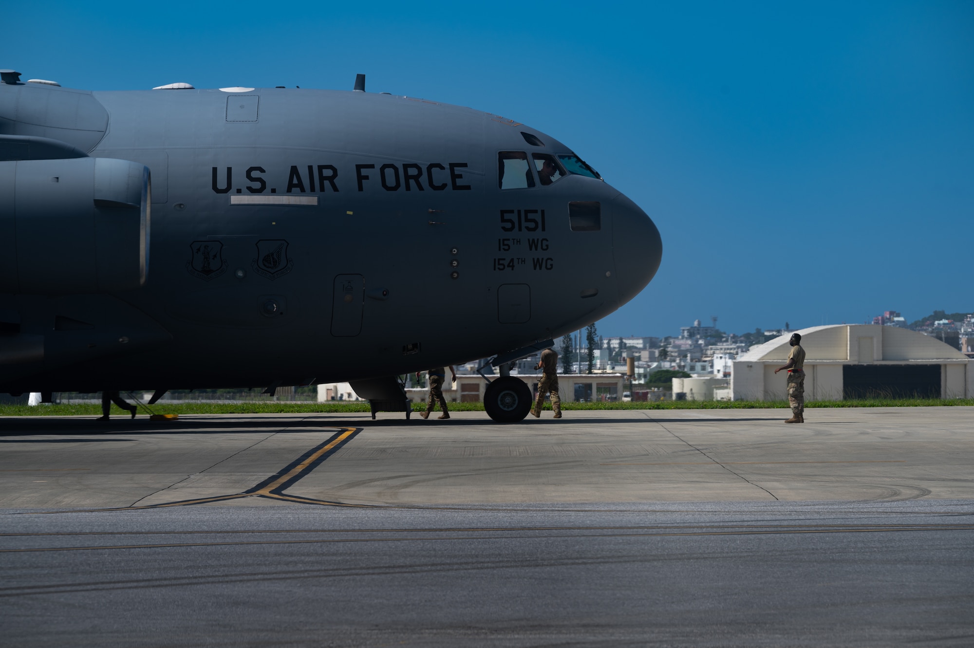A Joint Base Pearl-Harbor Hickam C-17 Globemaster III is inspected by customs at Kadena Air Base, Japan, Sept. 29, 2021. The C-17 Globemaster III  is capable of rapid strategic delivery of troops and all types of cargo to main operating bases or directly to forward bases in the deployment area. (U.S. Air Force photo by Airman 1st Class Stephen Pulter)