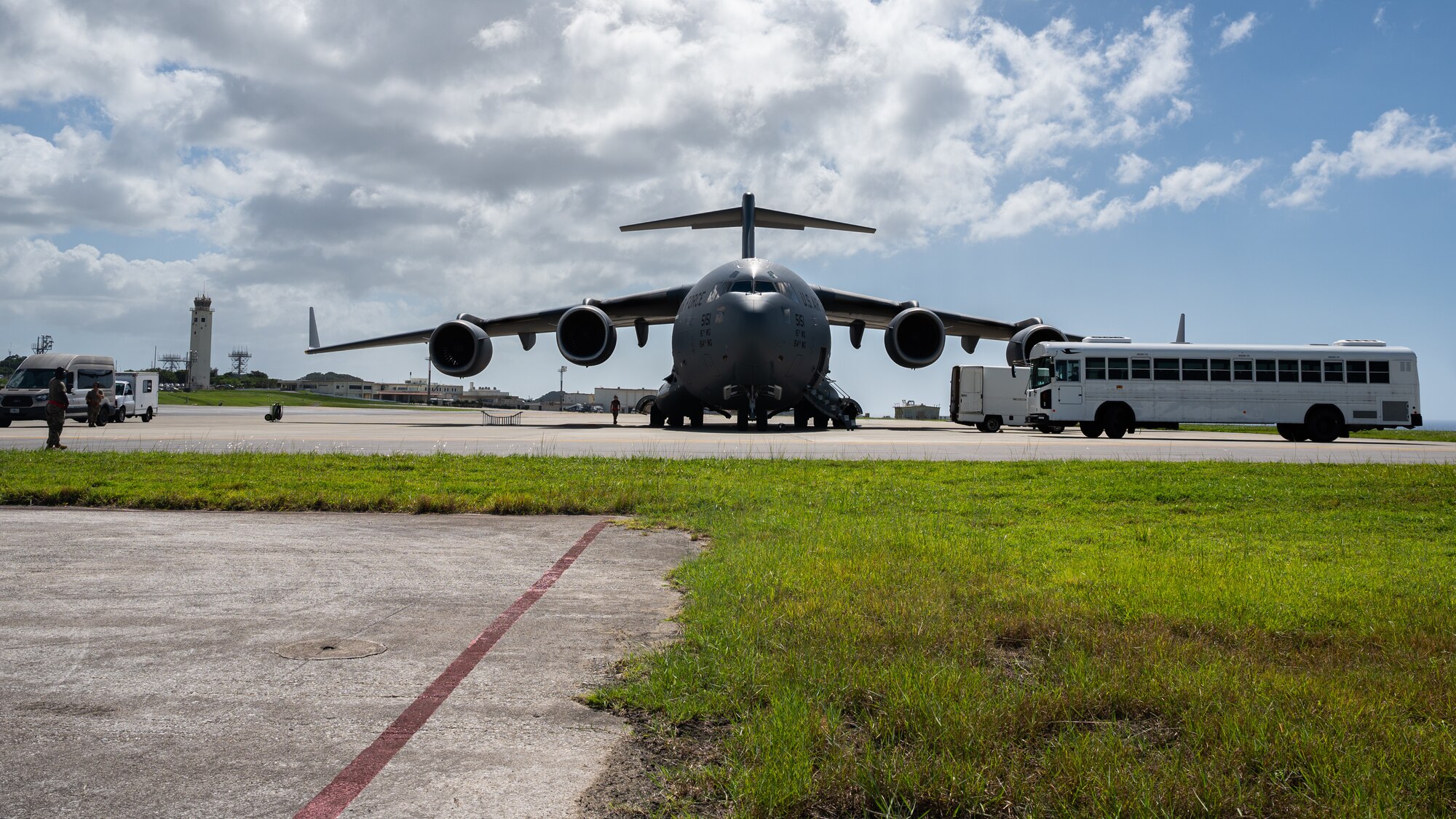 A Joint Base Pearl-Harbor Hickam C-17 Globemaster III off-loads passengers at Kadena Air Base, Japan, Sept. 29, 2021. The C-17 Globemaster III can perform tactical airlift and airdrop missions and can transport litters and ambulatory patients during aeromedical evacuations. (U.S. Air Force photo by Airman 1st Class Stephen Pulter)